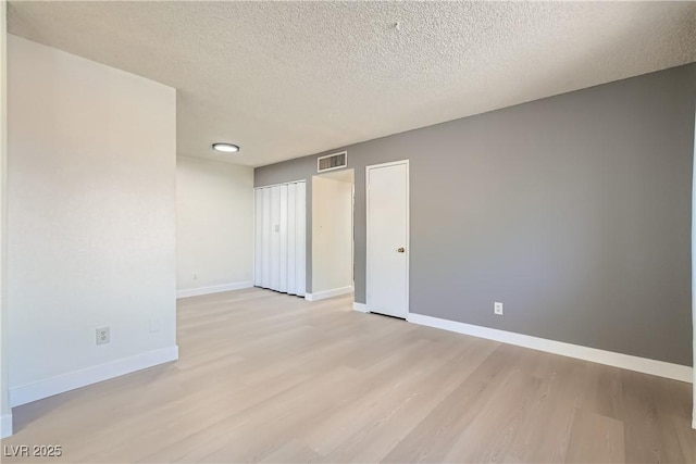 4683 Monterey Cir Unit 4, Las Vegas, NV 89169 - unfurnished bedroom with light wood-type flooring and a textured ceiling