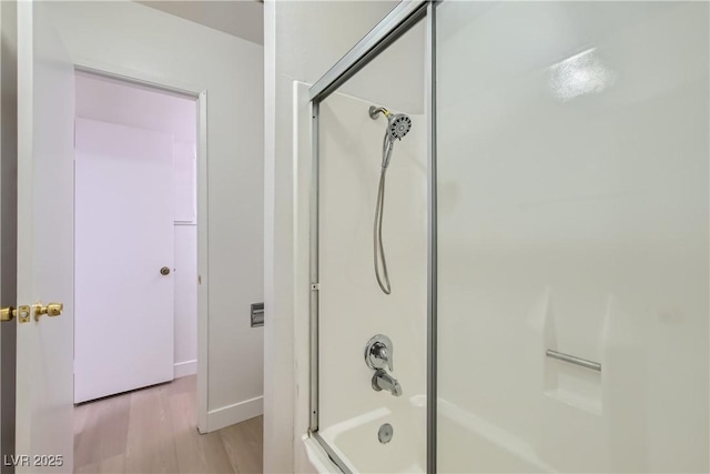 4683 Monterey Cir Unit 4, Las Vegas, NV 89169 - bathroom featuring combined bath / shower with glass door and wood finished floors