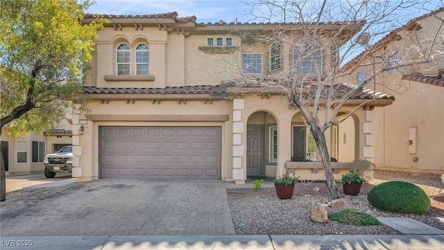 8139 Skytop Ledge Ave, Las Vegas, NV 89178 - mediterranean / spanish home with an attached garage, driveway, stucco siding, and a tile roof