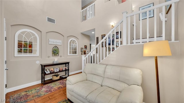 8139 Skytop Ledge Ave, Las Vegas, NV 89178 - living area with stairway, wood finished floors, and a towering ceiling
