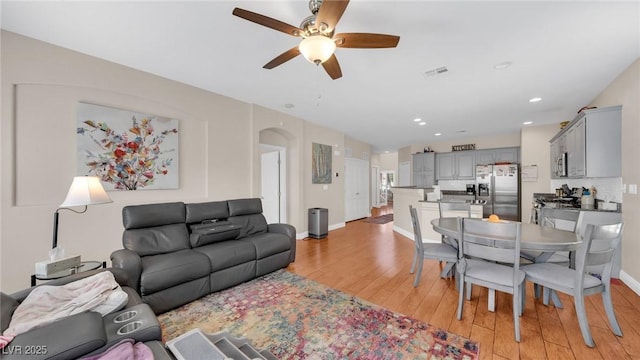 8139 Skytop Ledge Ave, Las Vegas, NV 89178 - living room with arched walkways, ceiling fan, light wood-style flooring, and recessed lighting