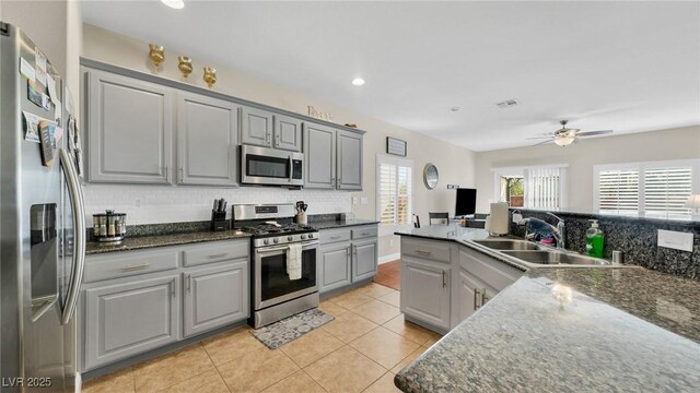 8139 Skytop Ledge Ave, Las Vegas, NV 89178 - kitchen featuring stainless steel appliances, gray cabinetry, backsplash, light tile patterned floors, and recessed lighting