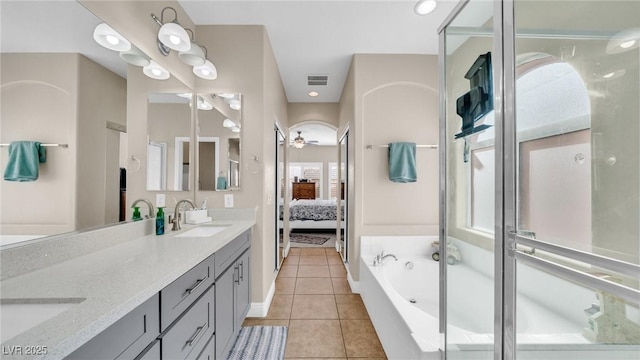 8139 Skytop Ledge Ave, Las Vegas, NV 89178 - ensuite bathroom featuring double vanity, tile patterned flooring, a bath, a shower stall, and ceiling fan