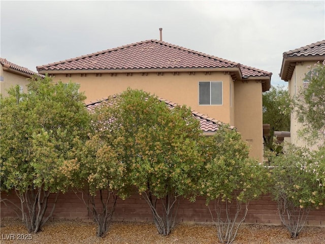 8139 Skytop Ledge Ave, Las Vegas, NV 89178 - view of side of property with a tiled roof and stucco siding