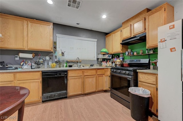 4215 Macadamia Dr, Las Vegas, NV 89115 - kitchen featuring freestanding refrigerator, black dishwasher, gas range, under cabinet range hood, and light wood-type flooring