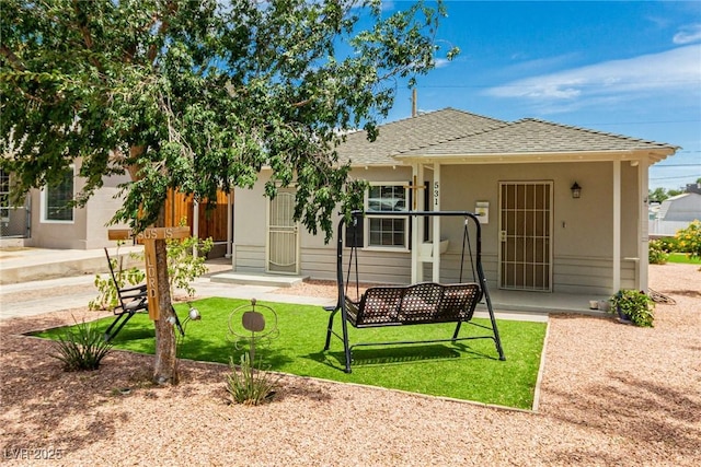 531 New Mexico St, Boulder City, NV 89005 - rear view of house featuring a shingled roof, stucco siding, and a lawn