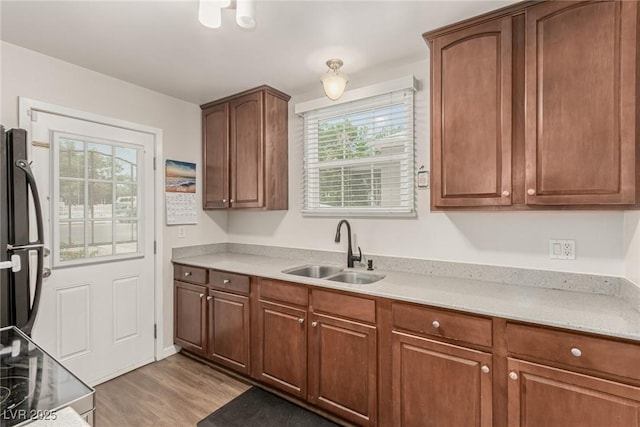 531 New Mexico St, Boulder City, NV 89005 - kitchen featuring freestanding refrigerator, light wood-style flooring, light countertops, and range