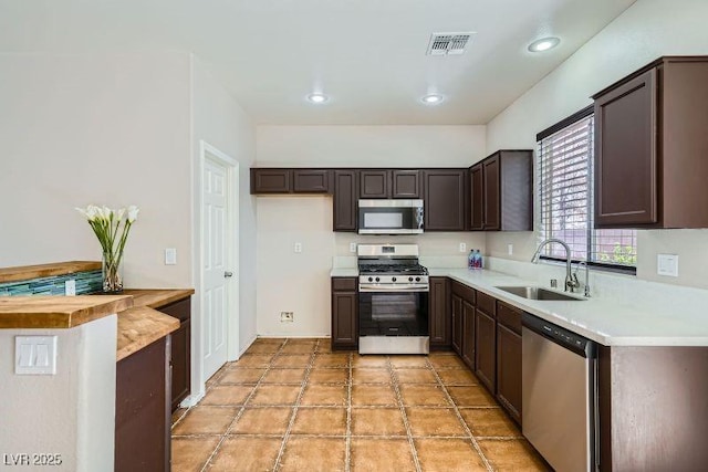 10719 Tottenham Ave, Las Vegas, NV 89135 - kitchen with appliances with stainless steel finishes, dark brown cabinetry, light countertops, and recessed lighting