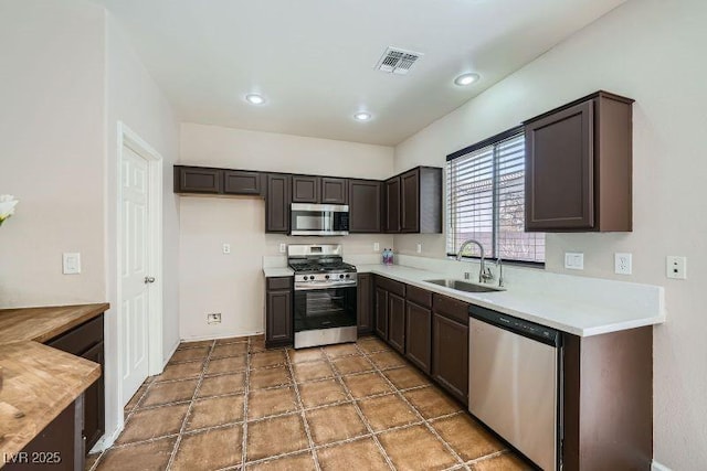 10719 Tottenham Ave, Las Vegas, NV 89135 - kitchen featuring stainless steel appliances, dark brown cabinets, and light countertops