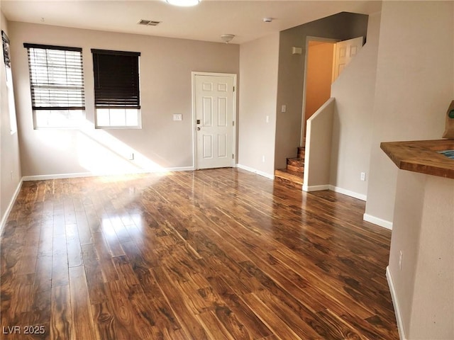 10719 Tottenham Ave, Las Vegas, NV 89135 - empty room with dark wood-type flooring and stairway