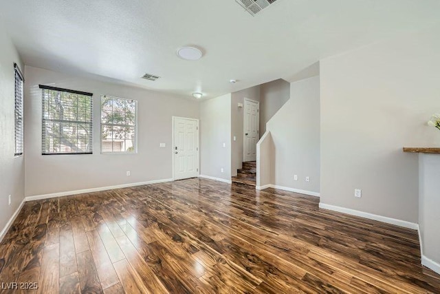 10719 Tottenham Ave, Las Vegas, NV 89135 - unfurnished living room with dark wood-style floors and baseboards
