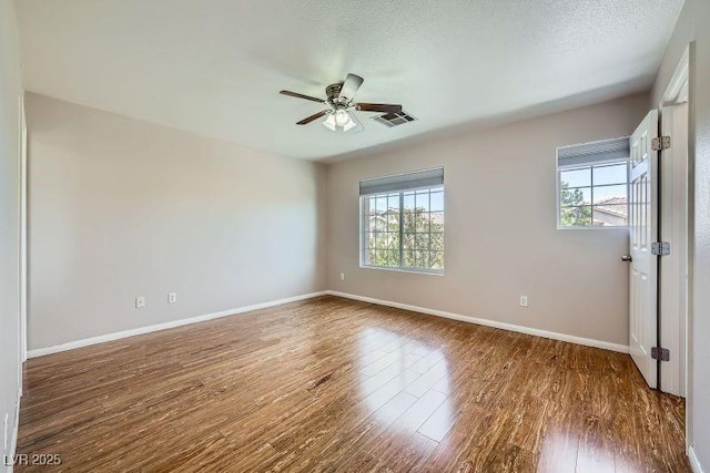 10719 Tottenham Ave, Las Vegas, NV 89135 - empty room with healthy amount of natural light, ceiling fan, and wood finished floors