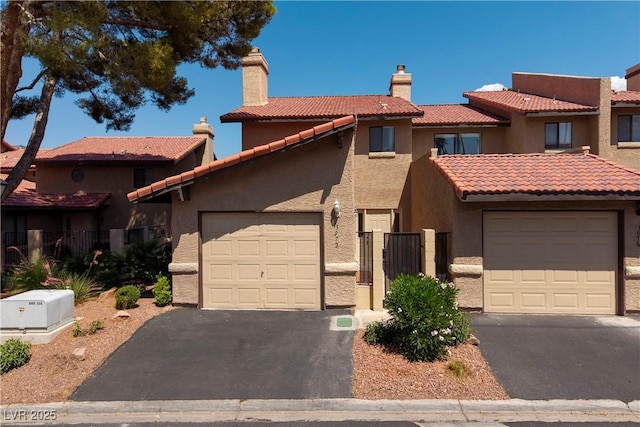 3972 Tirana Way, Las Vegas, NV 89103 - view of front of house featuring stucco siding, asphalt driveway, a tiled roof, a garage, and a chimney