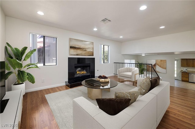 3972 Tirana Way, Las Vegas, NV 89103 - living room featuring plenty of natural light, recessed lighting, wood finished floors, and a fireplace