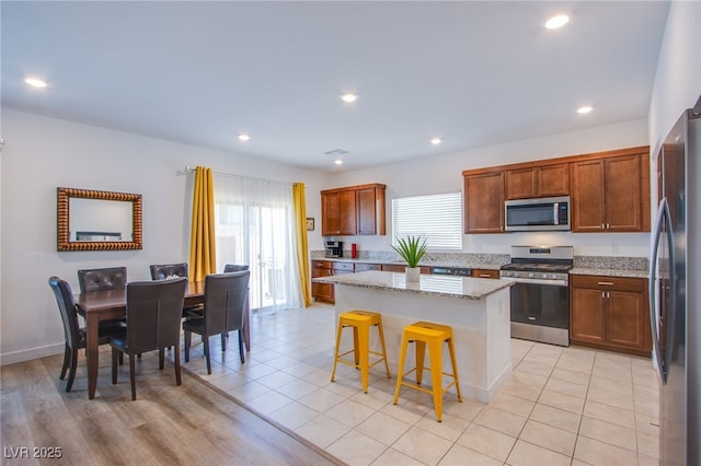 10435 Rose Palisade St, Las Vegas, NV 89141 - kitchen featuring appliances with stainless steel finishes, a kitchen island, plenty of natural light, a breakfast bar, and recessed lighting