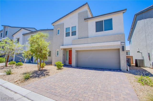 10435 Rose Palisade St, Las Vegas, NV 89141 - view of front facade with an attached garage, stucco siding, and decorative driveway
