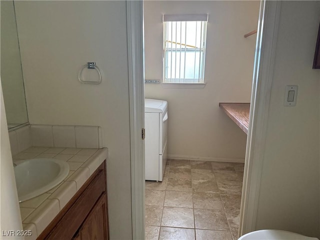 3090 N Woodchips Rd, Pahrump, NV 89060 - bathroom with washer and clothes dryer and vanity