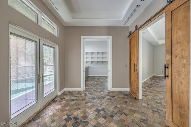 2017 Slow Wind St, Las Vegas, NV 89134 - empty room featuring a barn door, stone finish floors, french doors, and a tray ceiling