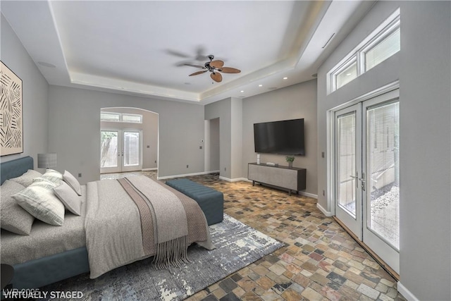 2017 Slow Wind St, Las Vegas, NV 89134 - bedroom featuring french doors, a tray ceiling, access to exterior, stone finish flooring, and recessed lighting