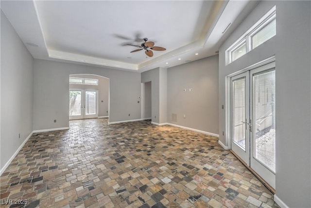 2017 Slow Wind St, Las Vegas, NV 89134 - unfurnished room featuring french doors, a raised ceiling, stone finish flooring, a ceiling fan, and recessed lighting