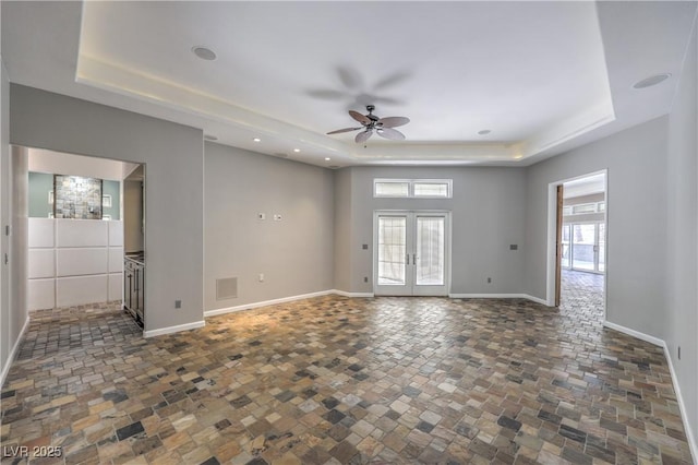 2017 Slow Wind St, Las Vegas, NV 89134 - empty room with a tray ceiling, ceiling fan, healthy amount of natural light, stone finish flooring, and recessed lighting