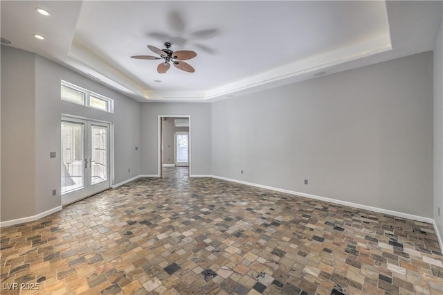 2017 Slow Wind St, Las Vegas, NV 89134 - unfurnished room with a raised ceiling, ceiling fan, french doors, stone finish floors, and recessed lighting