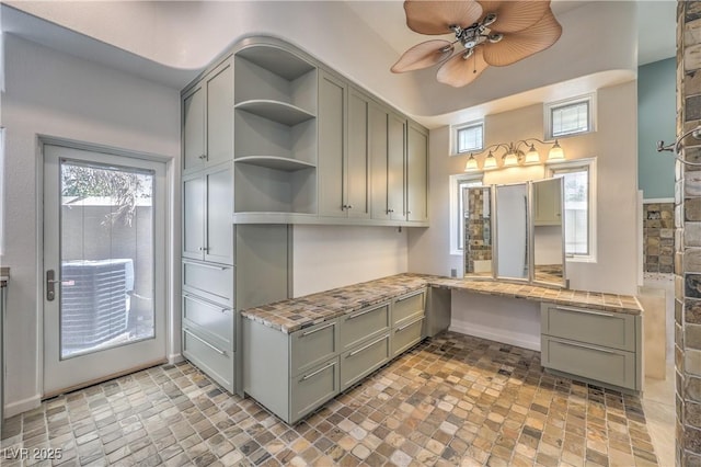 2017 Slow Wind St, Las Vegas, NV 89134 - kitchen with built in desk, gray cabinets, open shelves, and a ceiling fan