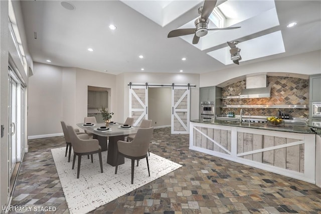 2017 Slow Wind St, Las Vegas, NV 89134 - dining space featuring a barn door, recessed lighting, ceiling fan, and a skylight