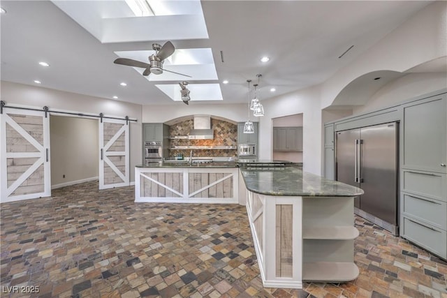 2017 Slow Wind St, Las Vegas, NV 89134 - kitchen featuring gray cabinets, stainless steel appliances, a barn door, open shelves, and recessed lighting