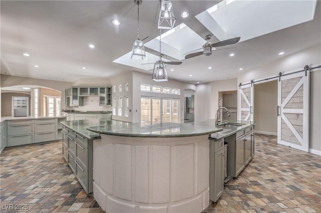 2017 Slow Wind St, Las Vegas, NV 89134 - kitchen with a spacious island, gray cabinetry, ceiling fan, a barn door, and recessed lighting