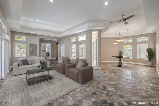 2017 Slow Wind St, Las Vegas, NV 89134 - living room with a tray ceiling, a ceiling fan, recessed lighting, and arched walkways
