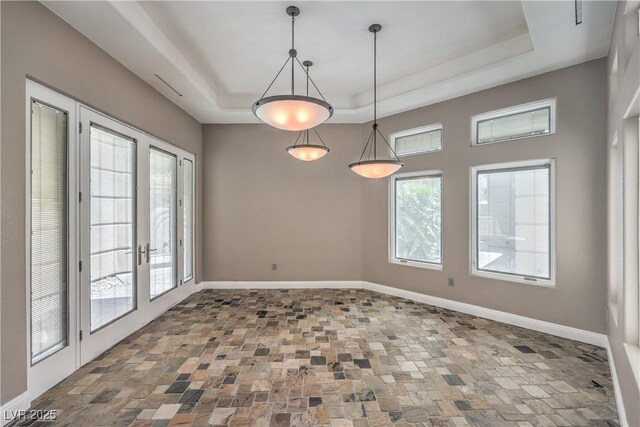 2017 Slow Wind St, Las Vegas, NV 89134 - spare room with a tray ceiling, french doors, and stone finish flooring