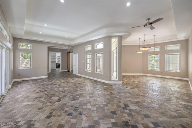 2017 Slow Wind St, Las Vegas, NV 89134 - unfurnished living room with a raised ceiling, ceiling fan, recessed lighting, and arched walkways