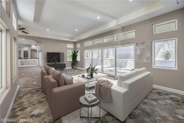 2017 Slow Wind St, Las Vegas, NV 89134 - living room with a raised ceiling, stone finish flooring, a ceiling fan, and recessed lighting