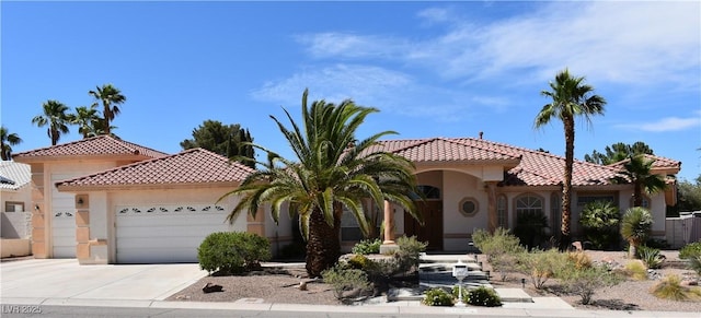 7250 Birkland Ct, Las Vegas, NV 89117 - mediterranean / spanish-style home featuring an attached garage, stucco siding, a tiled roof, and concrete driveway