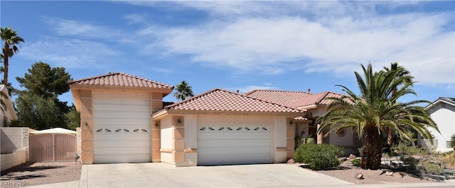 7250 Birkland Ct, Las Vegas, NV 89117 - view of front of home featuring an attached garage, stucco siding, a tile roof, and a gate