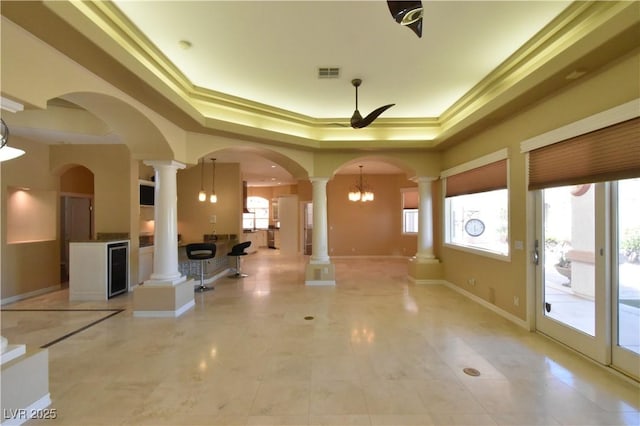 7250 Birkland Ct, Las Vegas, NV 89117 - entryway featuring decorative columns, a tray ceiling, ceiling fan, arched walkways, and crown molding