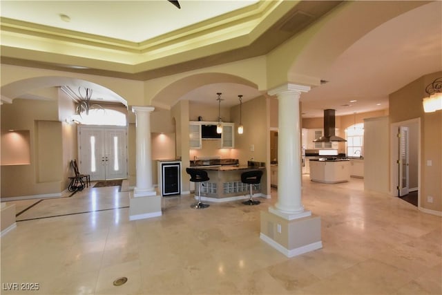 7250 Birkland Ct, Las Vegas, NV 89117 - entrance foyer featuring decorative columns, light tile patterned floors, arched walkways, and a raised ceiling