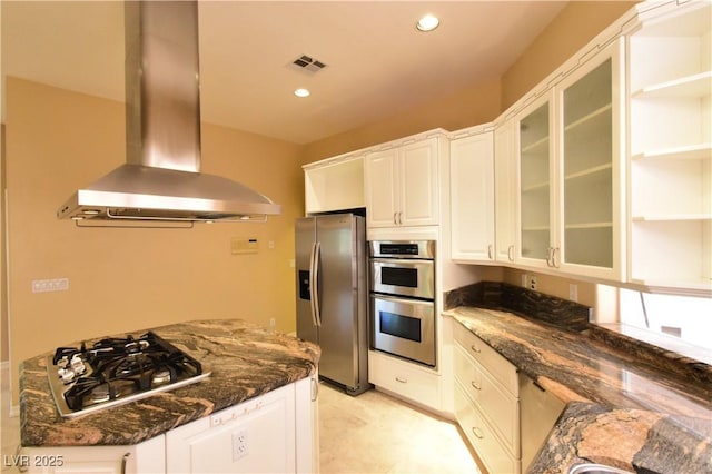 7250 Birkland Ct, Las Vegas, NV 89117 - kitchen with stainless steel appliances, island exhaust hood, dark stone counters, white cabinets, and recessed lighting