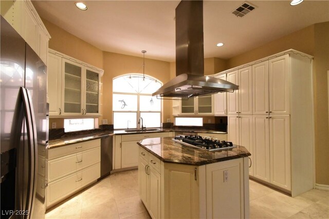 7250 Birkland Ct, Las Vegas, NV 89117 - kitchen featuring stainless steel appliances, island exhaust hood, recessed lighting, glass insert cabinets, and a center island