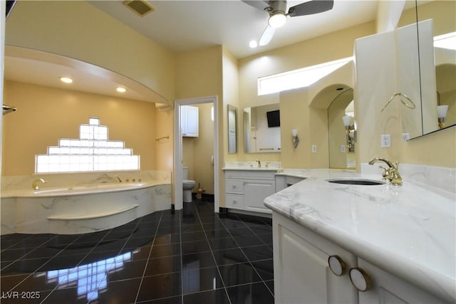 7250 Birkland Ct, Las Vegas, NV 89117 - bathroom with a bath, two vanities, recessed lighting, a ceiling fan, and tile patterned flooring