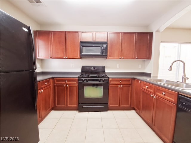 9069 Tantalizing Ave, Las Vegas, NV 89149 - kitchen featuring black appliances, dark countertops, light tile patterned floors, and dark brown cabinets