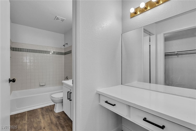 220 Mission Catalina Ln Unit 208, Las Vegas, NV 89107 - bathroom featuring vanity, wood finished floors, and shower / bath combination