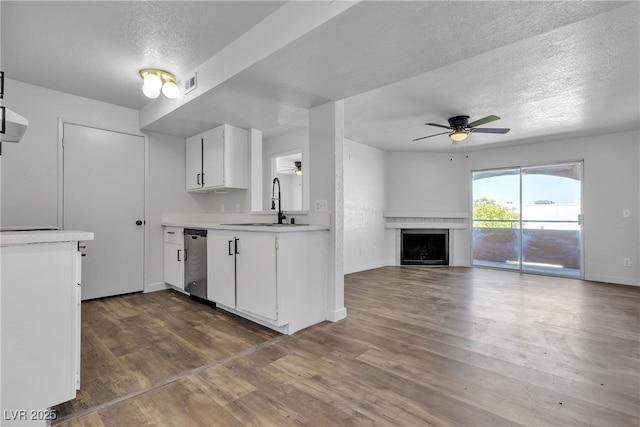 220 Mission Catalina Ln Unit 208, Las Vegas, NV 89107 - kitchen featuring a ceiling fan, stainless steel dishwasher, a textured ceiling, light countertops, and white cabinets
