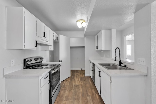 220 Mission Catalina Ln Unit 208, Las Vegas, NV 89107 - kitchen featuring stainless steel appliances, under cabinet range hood, a textured ceiling, dark wood finished floors, and light countertops