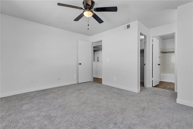 220 Mission Catalina Ln Unit 208, Las Vegas, NV 89107 - unfurnished bedroom with carpet flooring, a spacious closet, connected bathroom, and ceiling fan