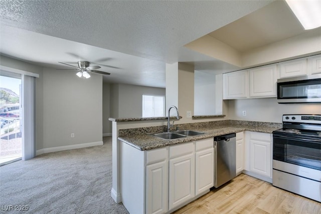 6800 E Lake Mead Blvd Unit 2072, Las Vegas, NV 89156 - kitchen with appliances with stainless steel finishes, white cabinetry, healthy amount of natural light, and a textured ceiling