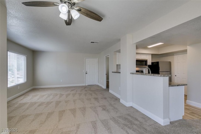 6800 E Lake Mead Blvd Unit 2072, Las Vegas, NV 89156 - unfurnished living room with light carpet and ceiling fan
