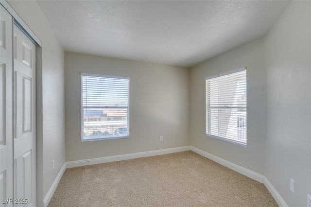 6800 E Lake Mead Blvd Unit 2072, Las Vegas, NV 89156 - empty room featuring light carpet and plenty of natural light
