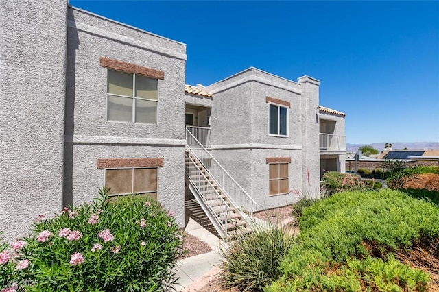 6800 E Lake Mead Blvd Unit 2072, Las Vegas, NV 89156 - view of side of property with stucco siding, stairway, and a balcony